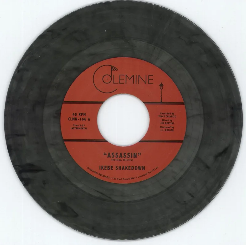 Ikebe Shakedown Assassin - Clear w/ Black Swirl Vinyl US 7" vinyl